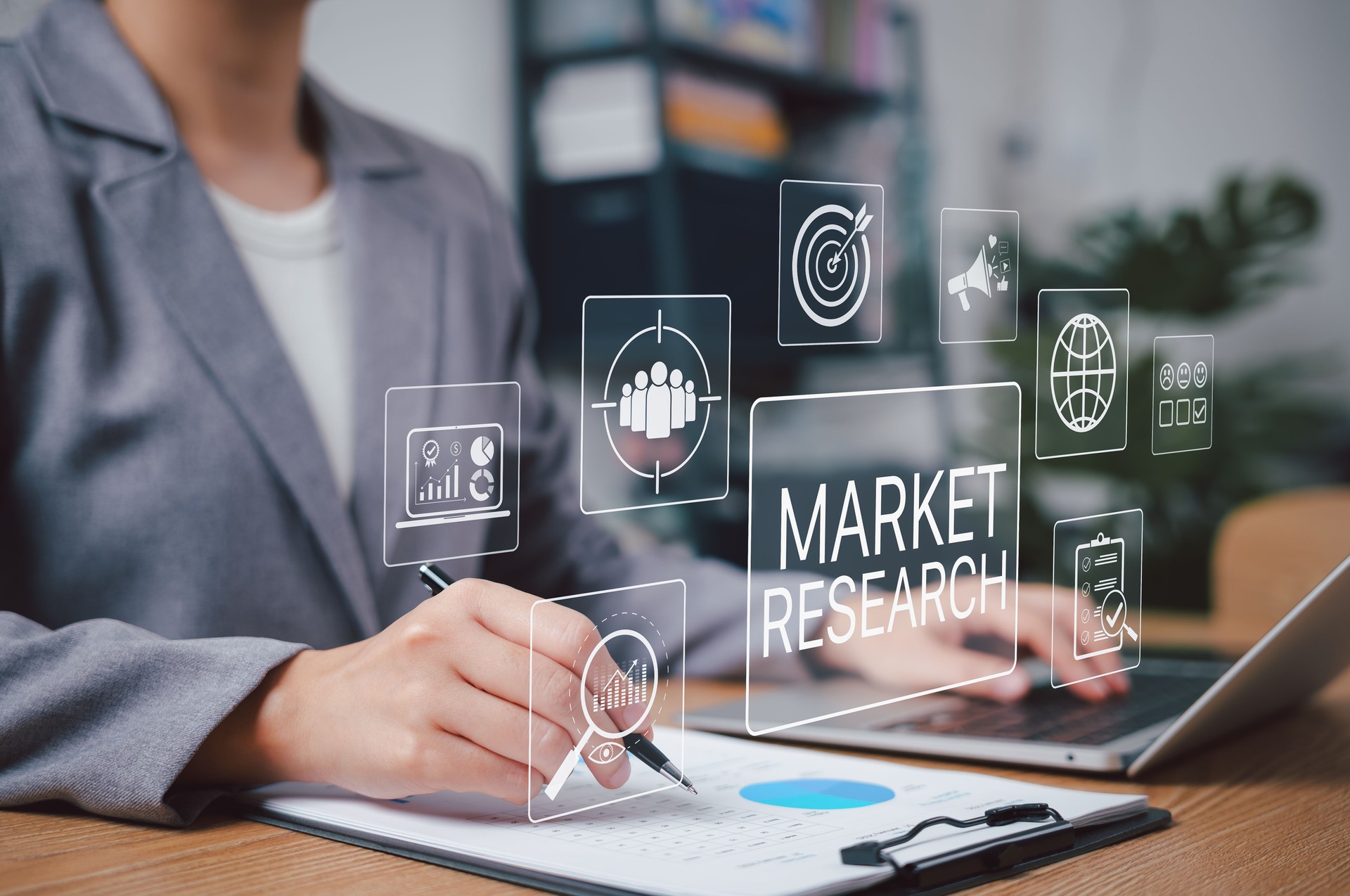 Market Research and Business Analysis Concept. Businesswoman working on market research with data graphics, charts, marketing icons, analytics, strategy, and business insights for decision making.